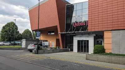 a building with a car parked in front of it at Kaszmir Sky Apartment by Vistula River in Kraków
