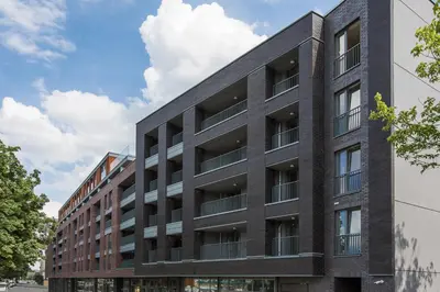 an office building with a black facade at Kaszmir Sky Apartment by Vistula River in Kraków