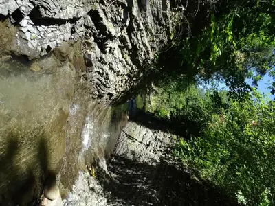 a rock wall with water coming out of it at Willa Potoczówka in Rzyki