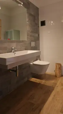 a bathroom with a sink and a toilet in it at Willa Potoczówka in Rzyki