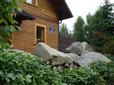 a pile of rocks in front of a building at Willa Potoczówka in Rzyki