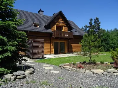 a log cabin with a pathway in front of a house at Willa Potoczówka in Rzyki