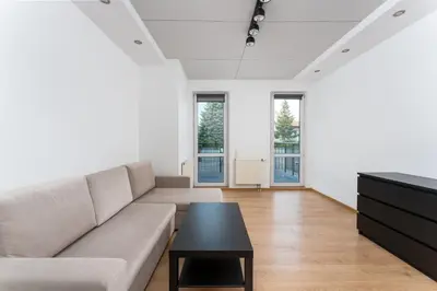 a living room with a couch and a table at Konecznego Urban Escape Studio by BookingHost in Kraków