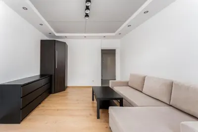 a living room with a couch and a table at Konecznego Urban Escape Studio by BookingHost in Kraków