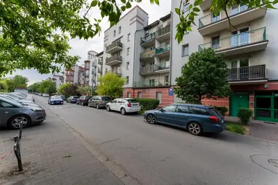a row of cars parked on the side of a city street at Konecznego Urban Escape Studio by BookingHost in Kraków