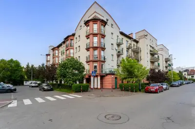 a large building with cars parked in a parking lot at Konecznego Urban Escape Studio by BookingHost in Kraków