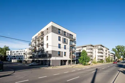 an apartment building on the corner of a street at Apartament Nova Płaszów in Kraków