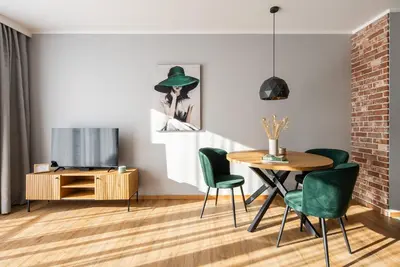 a dining room with a table and chairs and a television at Apartament Nova Płaszów in Kraków