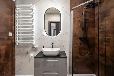 a bathroom with a sink and a mirror at Apartament Nova Płaszów in Kraków