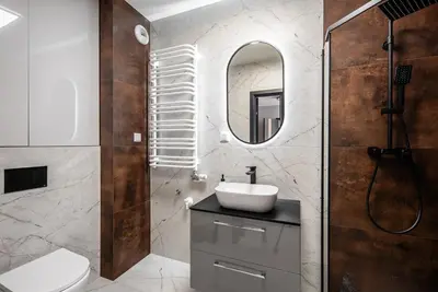 a bathroom with a sink and a mirror at Apartament Nova Płaszów in Kraków