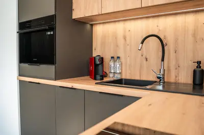 a kitchen with a sink and a counter top at K&M Apartments Tauron Arena, Lema in Kraków