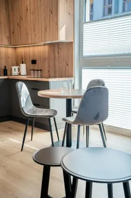 two tables and two chairs in a room at K&M Apartments Tauron Arena, Lema in Kraków