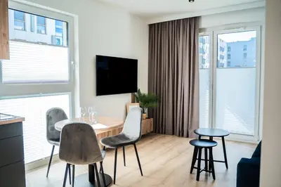 a living room with a table and chairs at K&M Apartments Tauron Arena, Lema in Kraków