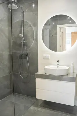 a bathroom with a sink and a mirror at K&M Apartments Tauron Arena, Lema in Kraków