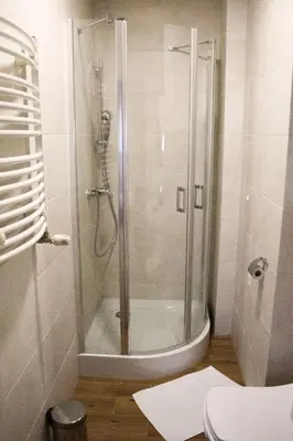 a shower with a glass door in a bathroom at Hotel - Restauracja Koral in Wieliczka