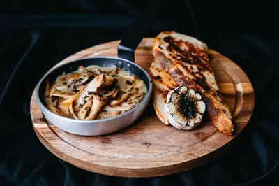 a plate of food with a bowl of mushrooms and bread at Hotel - Restauracja Koral in Wieliczka