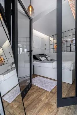 a bedroom with a bed and a mirror at Apartment Premium with Air Conditioning, city heart in Cracow in Kraków