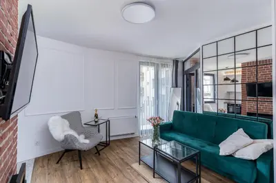 a living room with a green couch and a chair at Apartment Premium with Air Conditioning, city heart in Cracow in Kraków