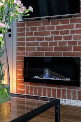 a brick fireplace with a fire in it at Apartment Premium with Air Conditioning, city heart in Cracow in Kraków