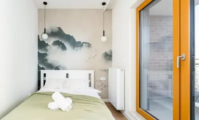 a bedroom with a bed with two white pillows at Malila Premium Apartments Cracow Rakowicka 437 in Kraków