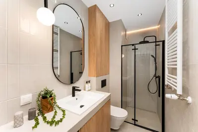 a bathroom with a sink and a mirror at Malila Premium Apartments Cracow Rakowicka 437 in Kraków