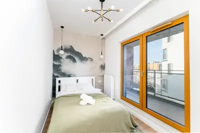 a bedroom with a bed and a window at Malila Premium Apartments Cracow Rakowicka 437 in Kraków