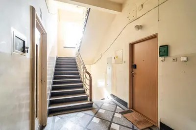 a hallway with stairs and a door in a building at ShortStayPoland Józefitów C4 in Kraków