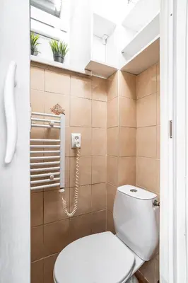 a bathroom with a toilet and a window at ShortStayPoland Józefitów C4 in Kraków