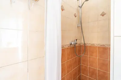 a bathroom with a shower with a glass door at ShortStayPoland Józefitów C4 in Kraków