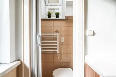 a small bathroom with a toilet in a room at ShortStayPoland Józefitów C4 in Kraków