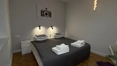 a bedroom with a bed with towels on it at B37 Kazimierz Apartment in Kraków