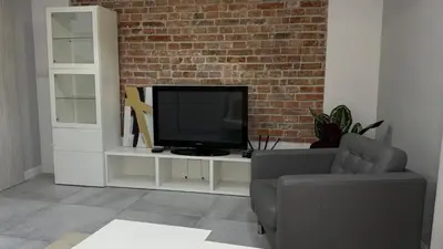 a living room with a television on a white entertainment center at B37 Kazimierz Apartment in Kraków