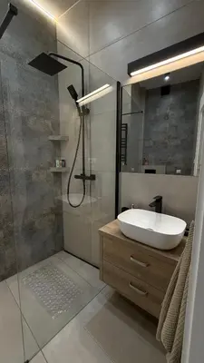 a bathroom with a sink and a glass shower at B37 Kazimierz Apartment in Kraków