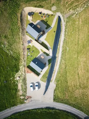 an overhead view of a group of cars parked in a field at Łyse Stodoły in Mordarka