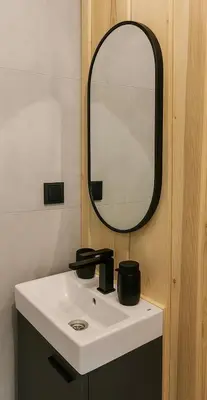 a bathroom with a sink and a mirror at Łyse Stodoły in Mordarka