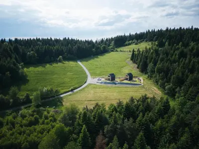 an aerial view of a field with trees and a road at Łyse Stodoły in Mordarka
