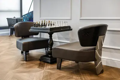 a chess game on a table and two chairs at Wings Plaza in Kraków