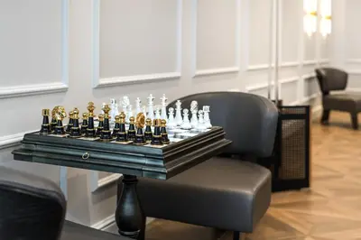 a chess set on a table on a chair at Wings Plaza in Kraków