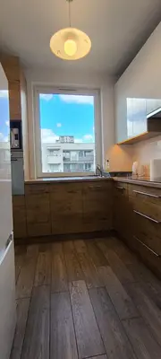 a large kitchen with a large window in a kitchen at Apartment Orlińskiego in Kraków