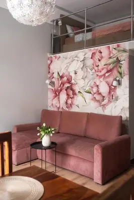 a living room with a pink couch and a floral wall at Loretas Roses Apartment Krakow Old Town in Kraków