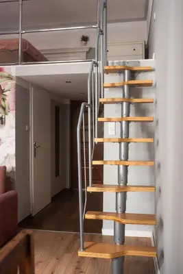 a staircase in a tiny house at Loretas Roses Apartment Krakow Old Town in Kraków