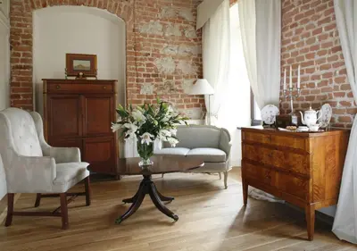 a living room with a couch and a table with flowers at Hotel Dwór Kościuszko in Kraków
