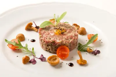 a plate of food with a piece of meat on it at Hotel Dwór Kościuszko in Kraków