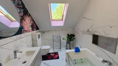 a bathroom with a sink and a toilet and a window at Domek Liliowe Marzenie in Chrzanów