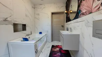 a white bathroom with two sinks and a mirror at Domek Liliowe Marzenie in Chrzanów
