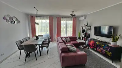 a living room with a couch and a table at Domek Liliowe Marzenie in Chrzanów
