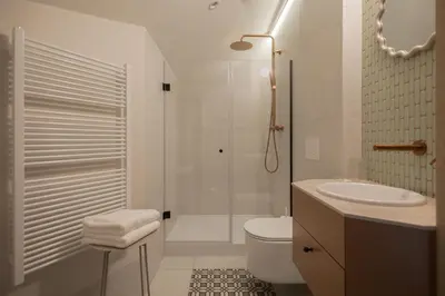 a bathroom with a shower and a toilet and a sink at Venus Apartment in Kraków