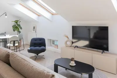 a living room with a couch and a tv at Venus Apartment in Kraków