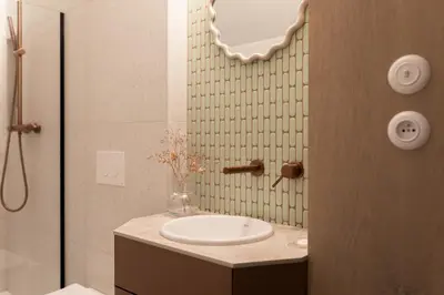 a bathroom with a sink and a shower at Venus Apartment in Kraków