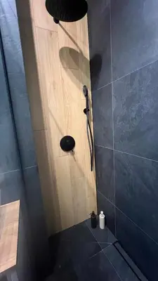 a shower with a shower head in a bathroom at Nowoczesny apartament w Makowie Podhalańskim in Maków Podhalański